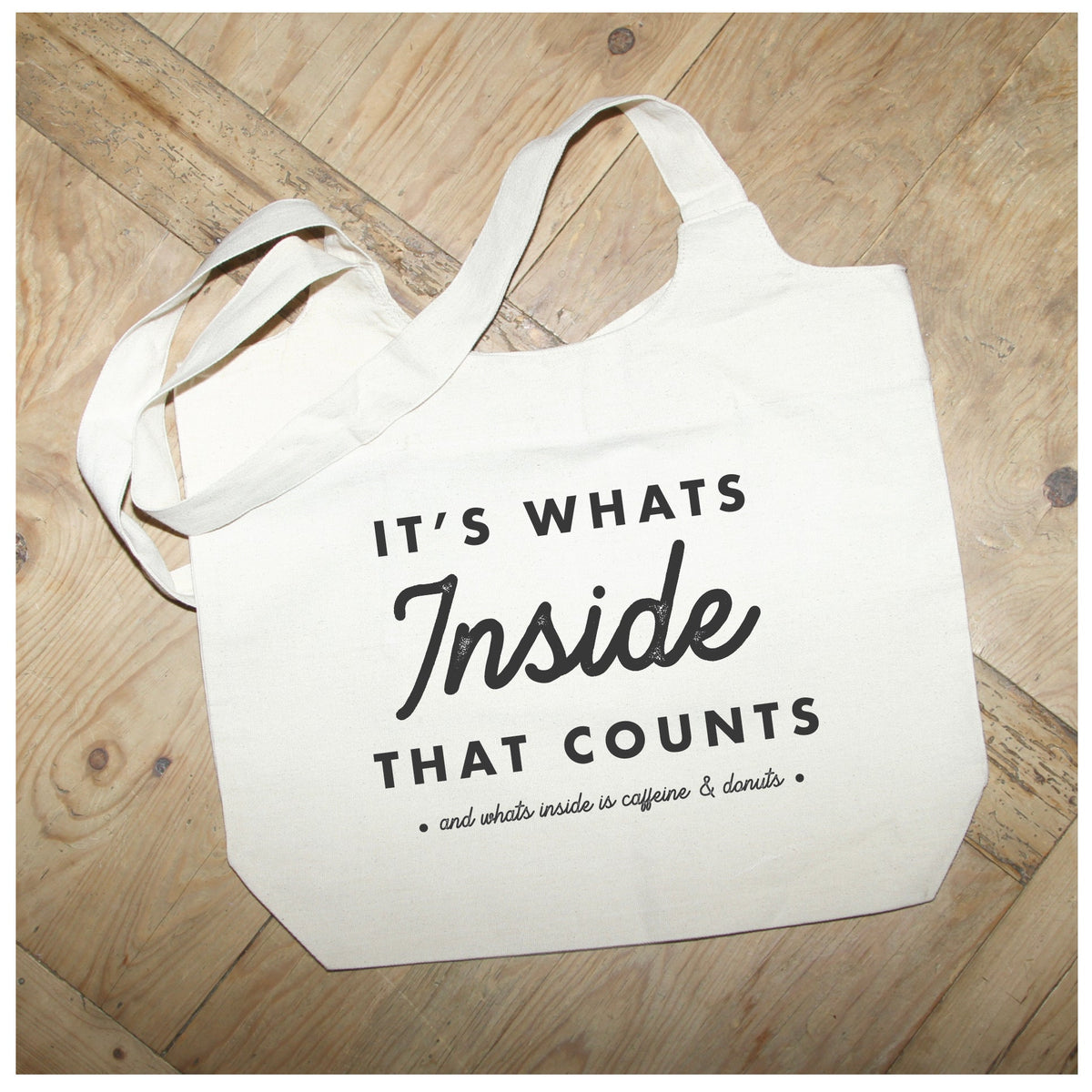 It's what's inside that counts (and what's inside is caffeine and donuts) / Natural Tote Bag